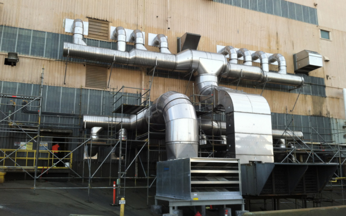 Large Metal Ductwork On Side Of An Industrial Building