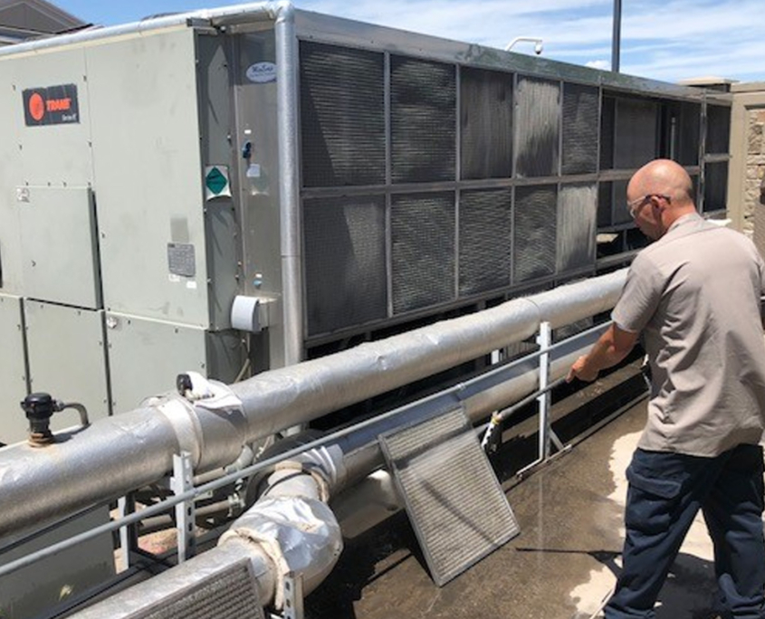 Man Working On Maintaining A Wolverine Hvac Unit