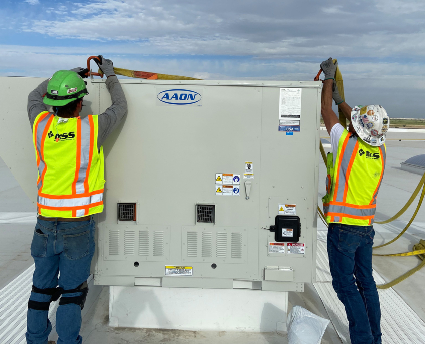 Mss Technicians Working On Cooling Units On Roof